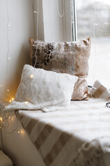 Cozy Pillows on Window Seat with Warm Lights