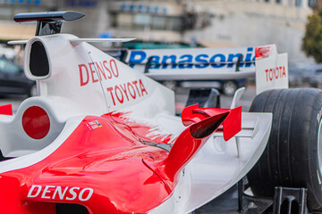 Obraz premium Formula 1 Toyota TF-108 car parked on tarmac, predominantly white with red and branding accents Notable features aerodynamic shapes, high rear wing, DENSO sponso - Kyiv, Ukraine 10-10-2024