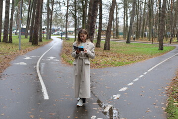 Fototapeta premium Woman Reading at a Fork in the Path