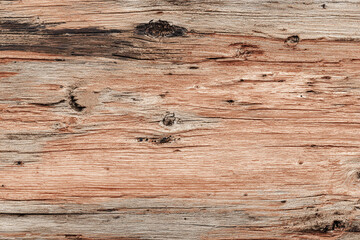 Close up texture of weathered wood with visible grain and knots