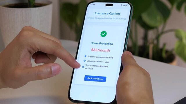 Close-up of a mans hands carefully studying the specific terms and premium of a home insurance policy on a mobile device. This clip represents the crucial evaluation phase before protecting ones