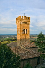 The crenellated medieval tower overlooking the plains and rooftops of the historic town of Bertinoro, Italy.