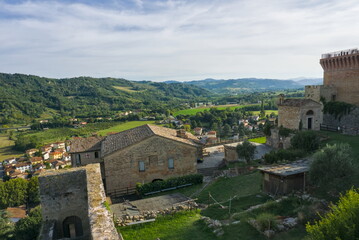 High-angle view of the historic Castrocaro Terme Fortress walls and tower overlooking the Romagna countryside.