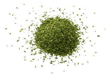 Pile of dried parsley flakes isolated on white background