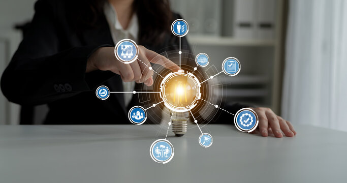 A business professional interacts with a visual display of digital icons representing innovative strategies and technology solutions for corporate growth and success. Crux