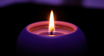 Close up of a single glowing purple candle flame