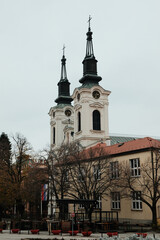 Obraz premium View of twin towers and rooftops in Sremski Karlovci, Serbia. A concept of heritage, winter mood, and cultural identity