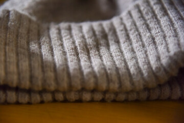 Fabric knitted wool textile. Close shot of a vintage, hand knit aran sweater