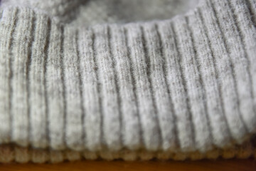 Fabric knitted wool textile. Close shot of a vintage, hand knit aran sweater