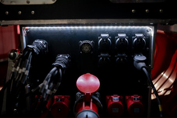 Power panel featuring multiple numbered outlets, industrial connectors, and rugged cables, showing the essential infrastructure that supports modern stage construction and major event power systems