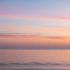 Obraz premium Serene Sunset Over Calm Ocean Waters with Soft Pastel Hues Painting the Sky