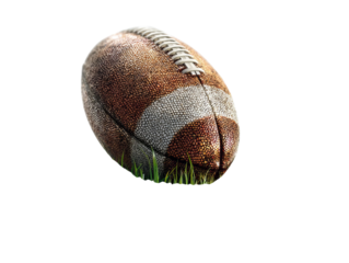 PNG of A close-up of a well-worn American football resting on lush green grass, showcasing its textured surface.