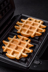 Belgian waffles, a healthy sweet breakfast dessert, food background. Belgian waffles