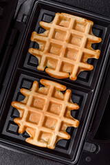 Belgian waffles, a healthy sweet breakfast dessert, food background. Belgian waffles