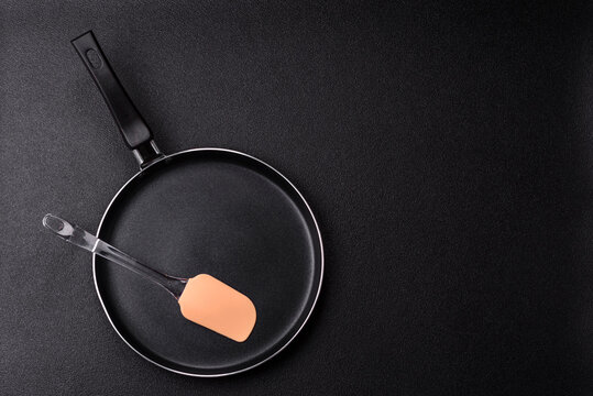 An empty black metal frying pan, kitchen utensils for cooking. An empty frying pan