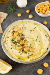 Lupini bean hummus with olive oil and herbs on gray background. Vegetarian food. 