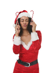 Beautiful woman in Mrs Claus costume with candy canes on white background. Christmas season