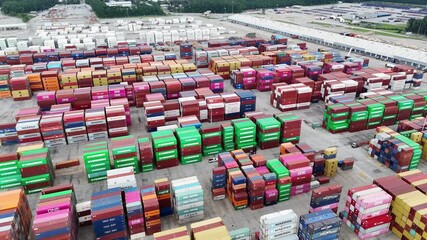 Top view of stacked shipping containers at a busy cargo terminal - Powered by Adobe