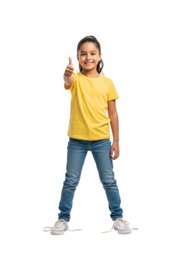full-length, hyper-photorealistic portrait of a radiant 7-year-old latina girl in a yellow t-shirt giving a thumbs-up gesture, isolated on a pristine white high-key studio background, concept of