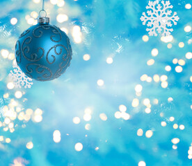 Christmas ball and snowflakes against blurred background with bokeh lights. Beautiful festive ornament