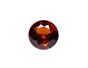 Close-up of a faceted, circular gemstone with intense reddish-brown color against black