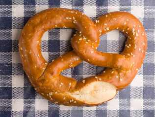 German pretzel against a checkered tablecloth