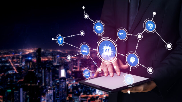 A businessman interacts with a tablet showcasing artificial intelligence icons against a vibrant city skyline at night, illustrating the intersection of technology and innovation. Tessel