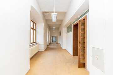 Long empty institutional corridor with natural light