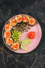 A warm serving of hot cooked sushi paired with green beans and a touch of wasabi for a flavorful fusion bite.