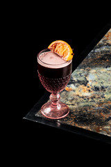 Close-up of hot mulled wine (Glühwein) served in a festive mug, with steam rising, creating a cozy...