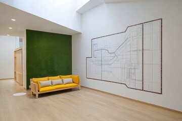 Modern Living Room with Green Accent Wall and Architectural Blueprint Artwork
