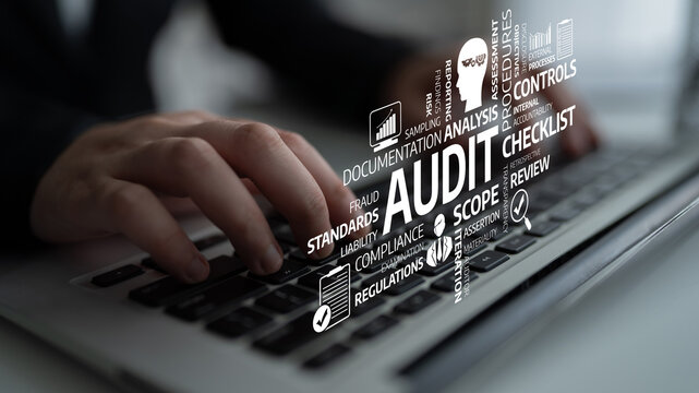 A close-up view of hands typing on a laptop with visuals representing audit processes and financial analysis, showcasing a modern workspace with compliance themes. Tessel
