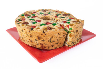 A homemade traditional light fruitcake on a white background.