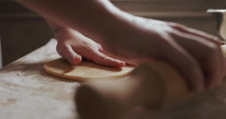 Housewife hands using cookie cutters to cut out Christmas cookies. Video with audio.
