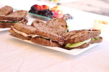 Sandwiches with black bread, on a white rectangular dish