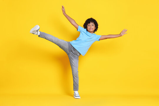 Portrait of little boy posing on yellow background - Powered by Adobe