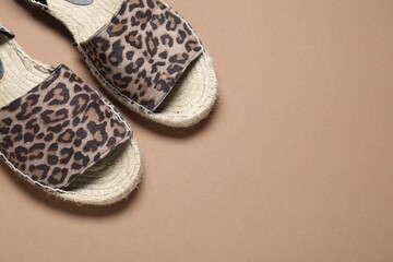 Pair of stylish shoes on beige background, flat lay. Space for text