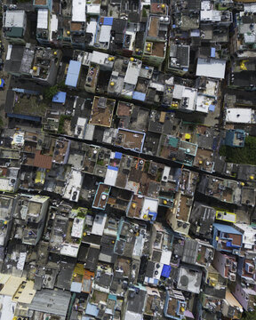 Aerial view of a densely packed neighborhood with colorful rooftops creating a vibrant mosaic of urban life from above, Chennai, Tamil Nadu, India.