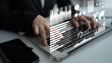 A professional office setting featuring a person typing on a laptop while interactive financial graphs and data visualizations hover above, illustrating modern analysis methods. Impute