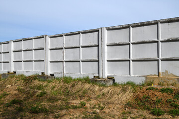 Obraz premium precast reinforced concrete fence consisting of individual panels,