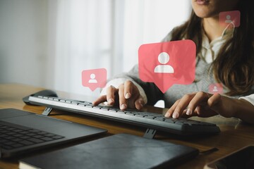 Woman working in an office with people location charts.