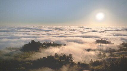 Aerial view of sunlight piercing through the clouds over Mount Tamalpais, creating a mystical landscape of light and shadow, Mount Tamalpais, California, United States.