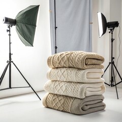 Stack of cozy wool sweaters in a professional studio setting, showcasing textures and colors, ideal for winter fashion and home decor inspiration with copy space