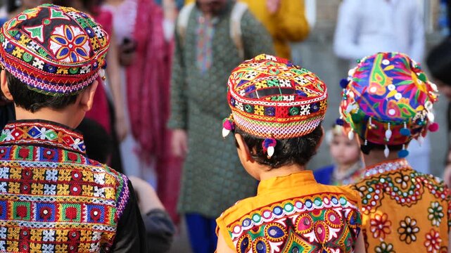 Young boys wearing traditional vibrant embroidered clothing celebrating Indian festival