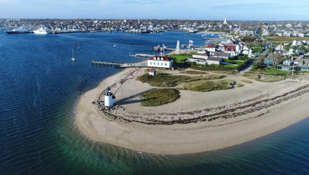 Aerial view of Brant Point Lighthouse standing sentinel on the sandy shore where the deep blue sea meets the island, Nantucket, Massachusetts, United States.
