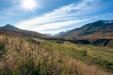 Mountain landscape with grass and blue sky. Caucasus, Russia.