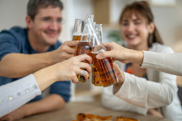 Celebrating friendship with cheers and drinks among friends during a casual gathering at home