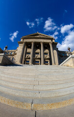 The building is very tall and has a lot of steps leading up to it