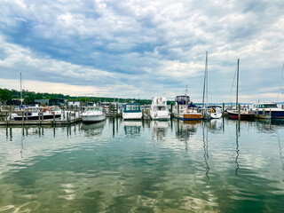Looking out over the tranquil turquoise blue waters of Lake Michigan to beautiful marina views. Sailboats and yachts are docked. Located in the Northern Michigan town of Harbor Springs.