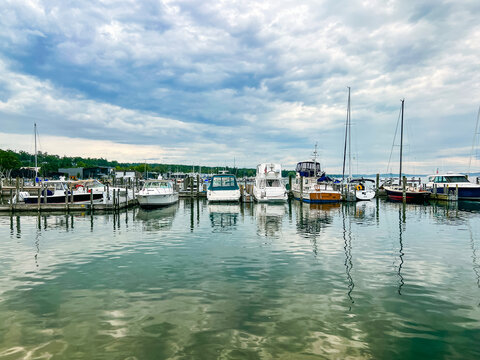 Looking out over the tranquil turquoise blue waters of Lake Michigan to beautiful marina views. Sailboats and yachts are docked. Located in the Northern Michigan town of Harbor Springs.